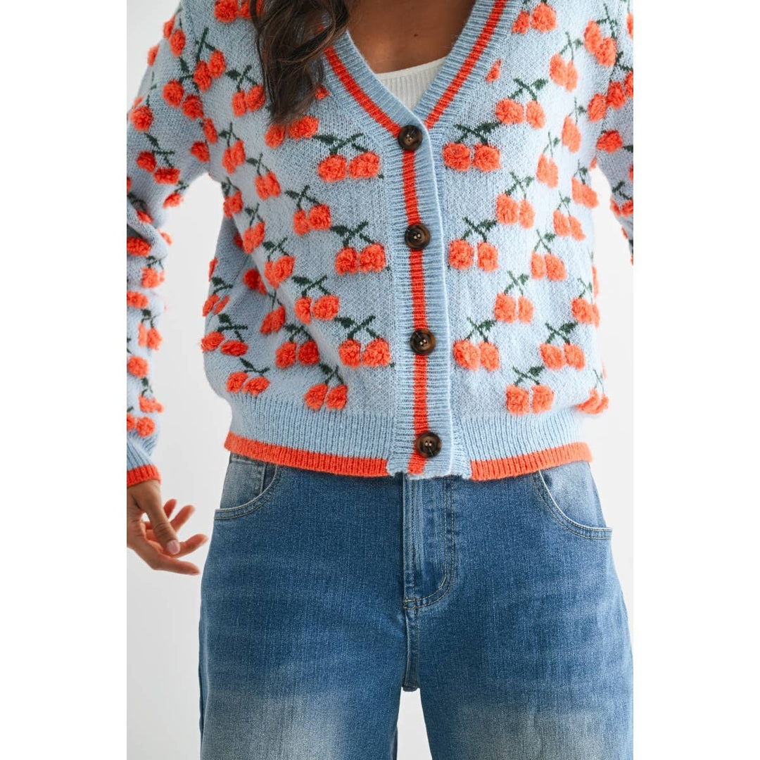 woman wearing a cherry red vintage sweater from For the Love LV boutique in Las Vegas