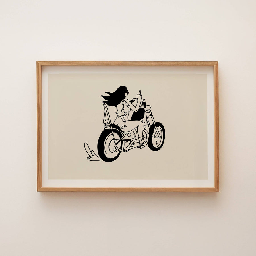Framed artwork of a black and white illustration of a person on a motorcycle on a beige background