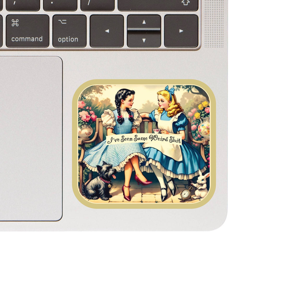Laptop with a sticker of two characters from 'Alice in Wonderland' holding hands.