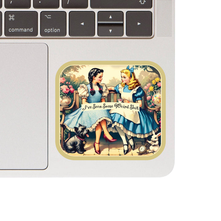 Laptop with a sticker of two characters from 'Alice in Wonderland' holding hands.
